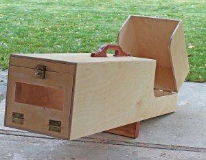 Wood animal trap viewed from end with a confirmation window