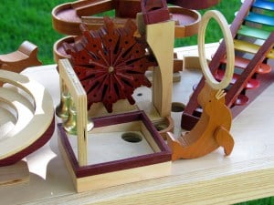 The xylophone plays as marble drop down each step