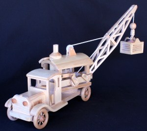 Wood crane with a load of rock. Crane and load can be raised