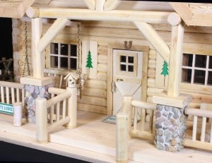 Door with a sliding latch, detailed windows and shutters and railings on the Lodge