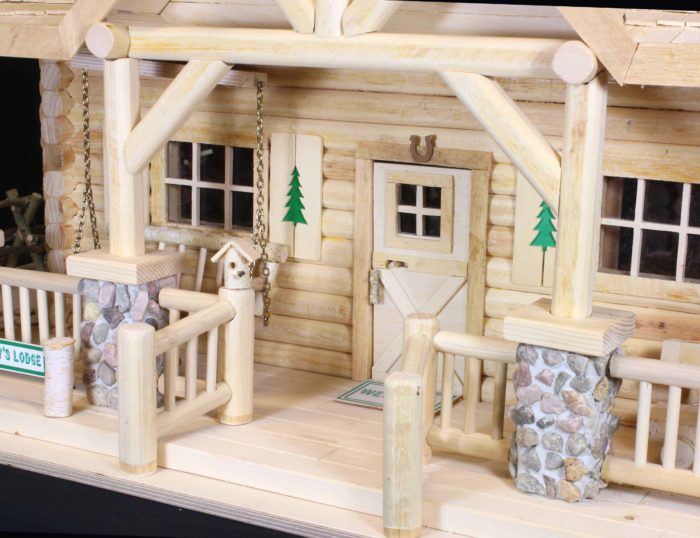 Door with a sliding latch, detailed windows and shutters and railings on the Lodge