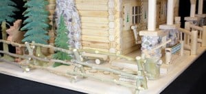 Trees, moose and a chopping block at the side of the lodge