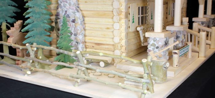 Trees, moose and a chopping block at the side of the lodge