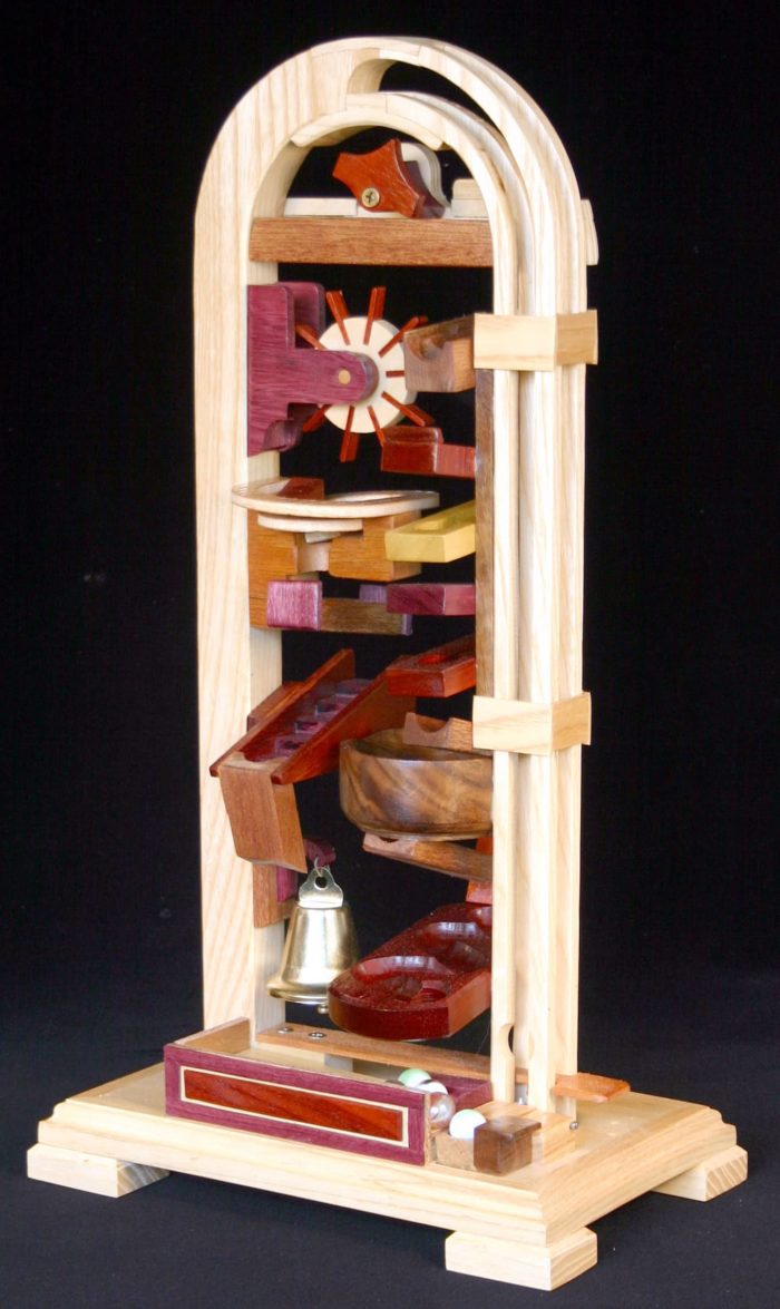 Fun action toy using marbles to drop, spin, ring a bell and zig zag through the obstacle course