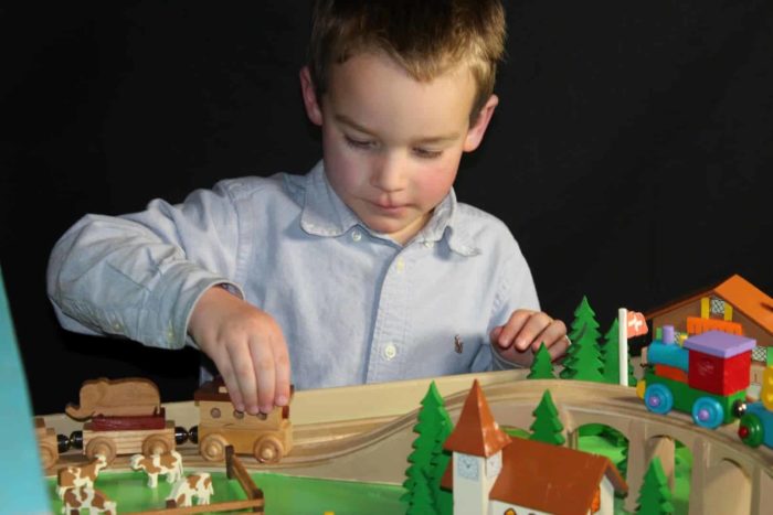 A giant train set woodworking playset with a Swiss theme